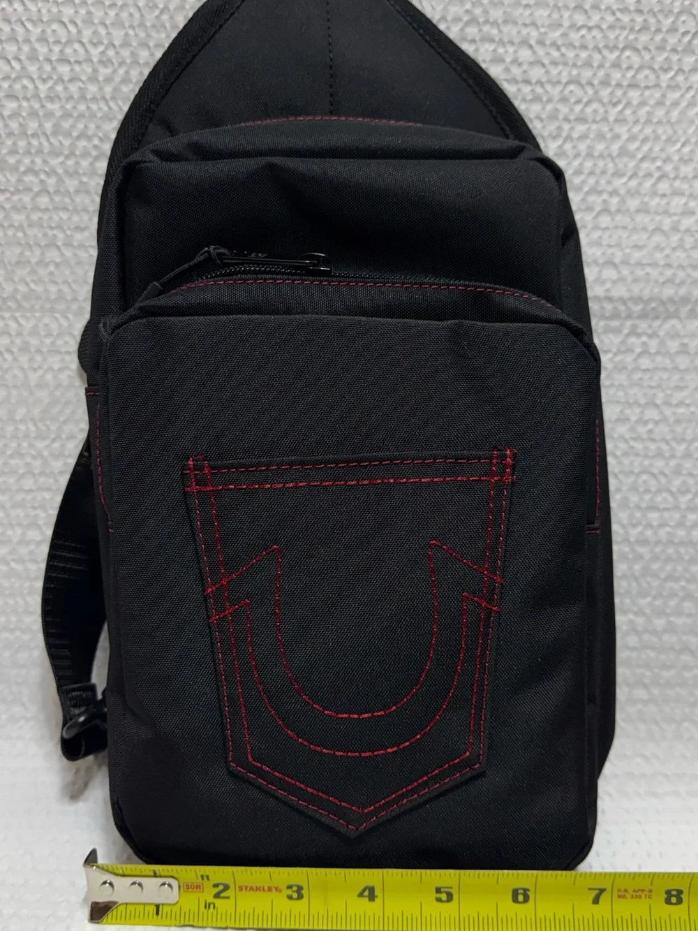 True religion travel sling black bag red horseshoe front